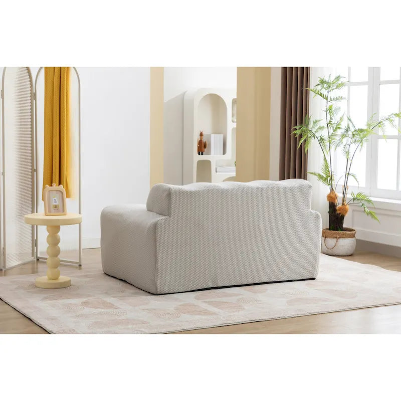 Fauteuil une place beige capitonné avec coussin en mousse haute densité
