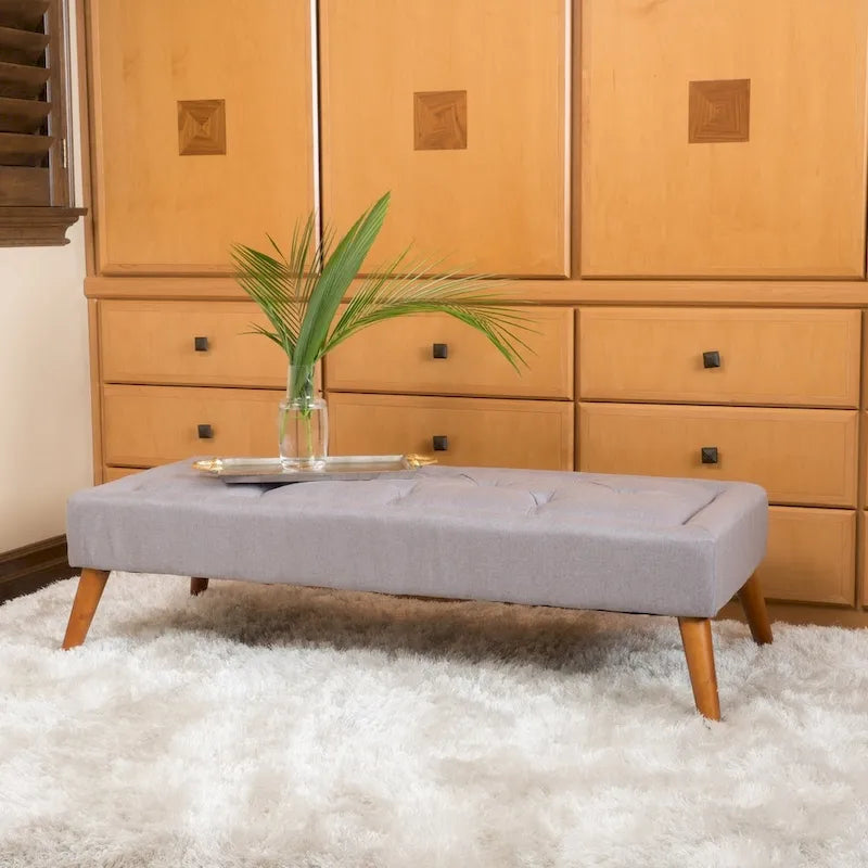 Banc ottoman en tissu capitonné avec pieds fuselés en bois multicolore