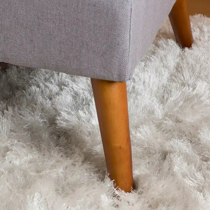 Banc ottoman en tissu capitonné avec pieds fuselés en bois multicolore